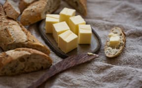 Cubes of butter and sliced baguette