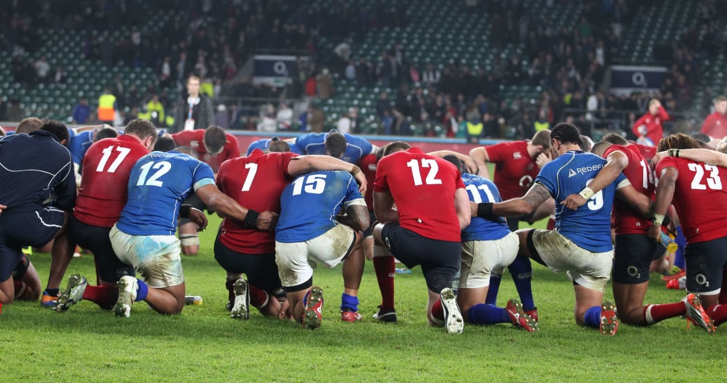 Manu Samoa and England players join for a prayer post-match.