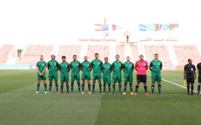 The Cook Islands stand for the national anthem prior to their match against Solomon Islands.
