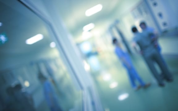 Health care workers in the hospital corridor.
