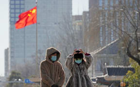 People wearing face masks are seen in Beijing, China on January 7, 2025. Chinese media reports that the respiratory infection “human metapneumovirus” (hMPV) is spreading in China. The Chinese Center for Disease Control and Prevention published data showing that respiratory infections had risen significantly in the week of 16 to 22 December 2024.( The Yomiuri Shimbun ) (Photo by Ichiro Ohara / Yomiuri / The Yomiuri Shimbun via AFP)