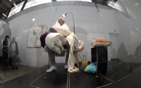 French artist Abraham Poincheval incubates eggs at the Palais de Tokyo musuem in Paris.