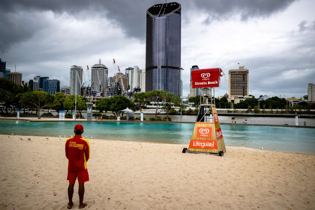 A lifeguard stands watch over a deserted South Bank beach on the first day of a snap lockdown in Brisbane on 9 January