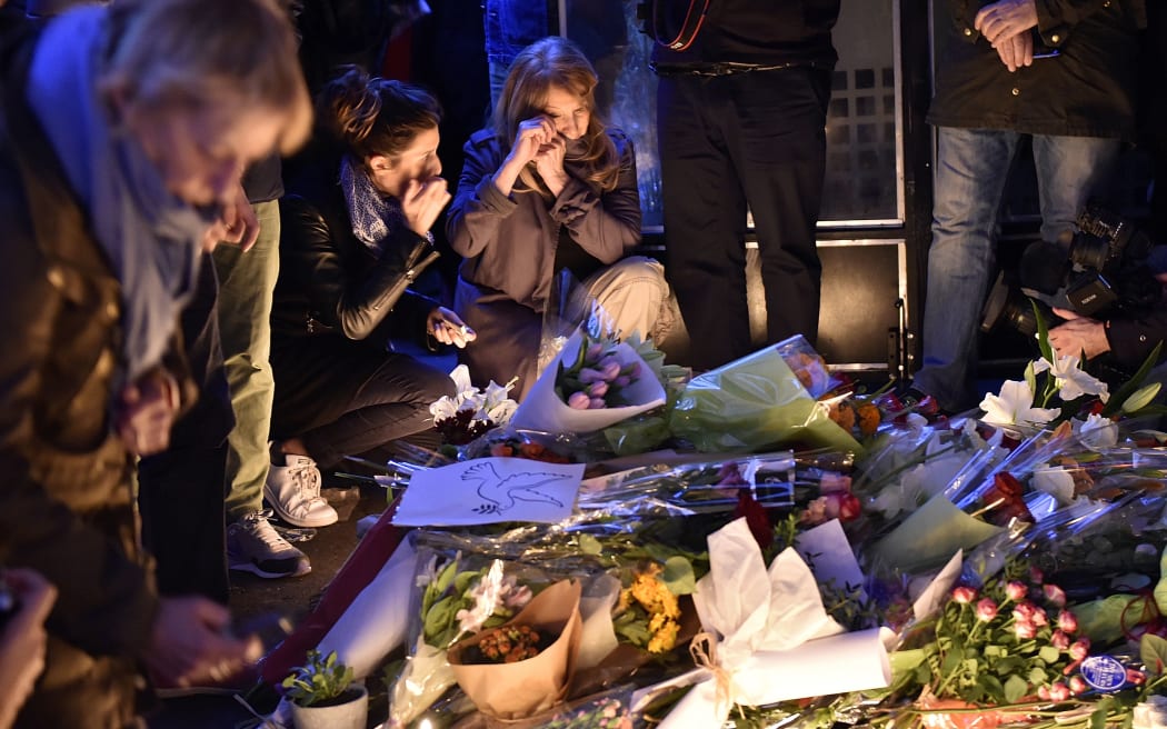 People place tributes to the victims of ' attacks at the cafe 'La Belle Equipe', Rue de Charonne.