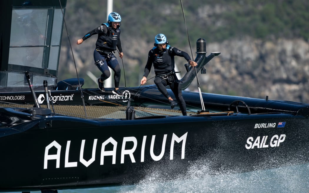 Liv Mackay, strategist of New Zealand SailGP Team and Blair Tuke, Co-CEO and wing trimmer of New Zealand SailGP Team run across the boat during racing on Lyttelton Harbour, 2023.