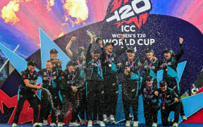 New Zealand's players celebrate with their winning trophy at the end of the ICC Women's T20 World Cup cricket.