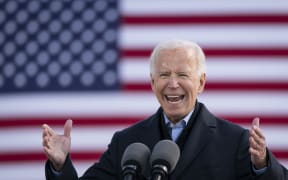 Democratic presidential nominee Joe Biden speaks during a drive-in campaign rally in Iowa. 30 October (file).