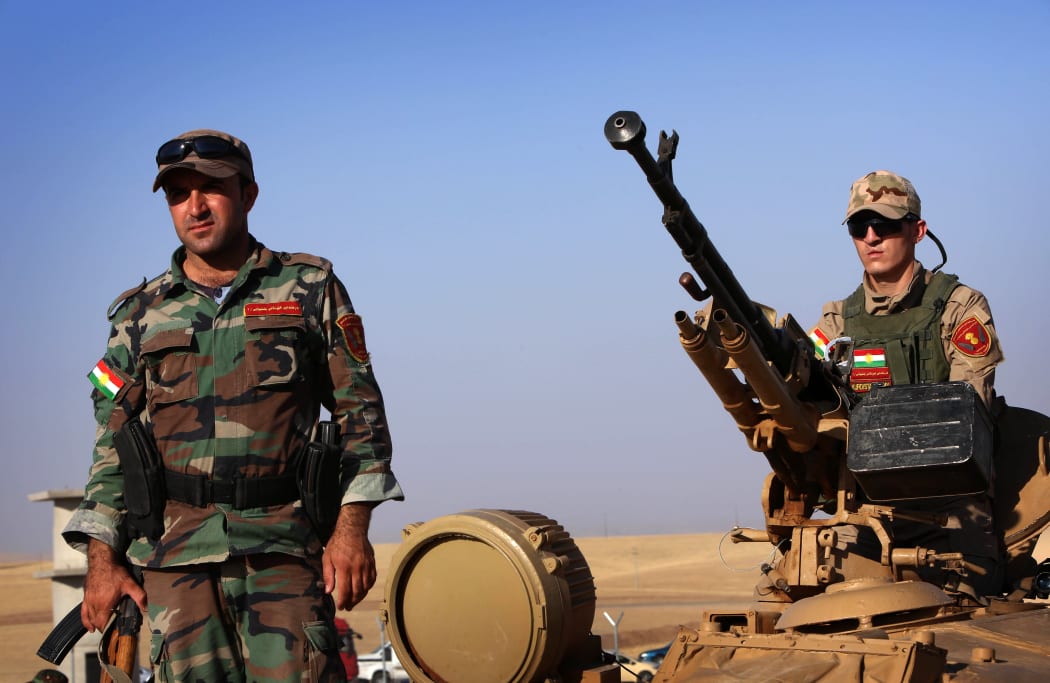 Iraqi Kurdish Peshmerga fighters take position on the front line in Khazer near Arbil, the capital of the autonomous Kurdish region of northern Iraq.