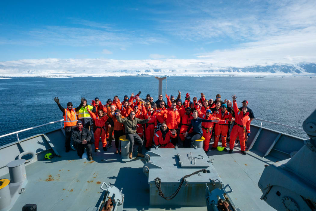Crew on the 2021 Antarctic voyage take a team photo off Daniell Peninsula.