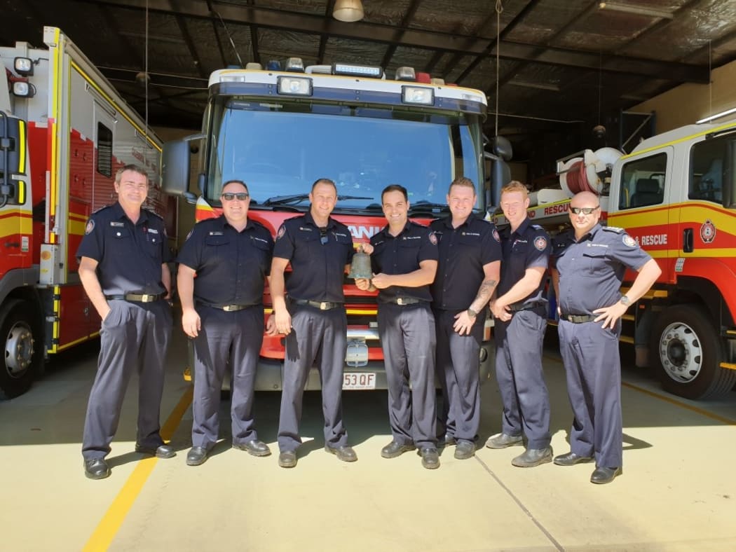 Mount Isa Queensland Fire and Emergency Services firefighters with the returned bell.