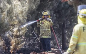 170224 CHRIS SKELTON / POOL
Firefighters continue their efforts on Saturday as they work to dampen down remaining hot spots and create a buffer zone around the 24km perimeter fire ground in Christchurch's Port Hills. Pictured Rural firefighter Aaron Kinnane (City Care firefighter)