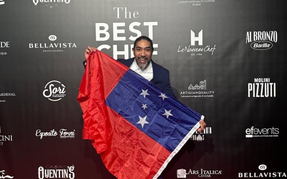 Image of Henry Onesemo holding a Samoan flag at the Best Chef Awards in Milan.