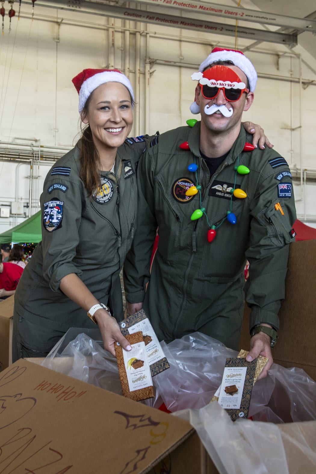 RNZAF aircraft captain Flight Lieutenant Michal-Louise Paget (left), says the RNZAF crew have included some ‘Kiwi treats’ such as New Zealand chocolate in the aid bundles as part of Operation Christmas Drop.