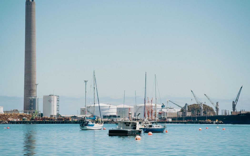The chimney from sea and across the harbour. Photo credit Taranaki Daily News