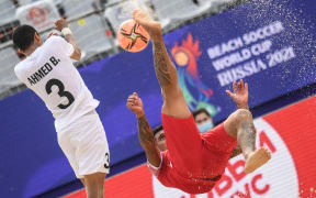Ahmed Beshr, of the United Arab Emirates, left, and Tahiti's Heimanu Taiarui struggle for the ball during the Beach Soccer World Cup group stage match between United Arab Emirates and Tahiti, in Moscow.