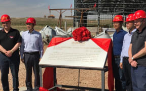 Marlborough District Council Mayor John Leggett  and other delegates unveil a plaque in China.