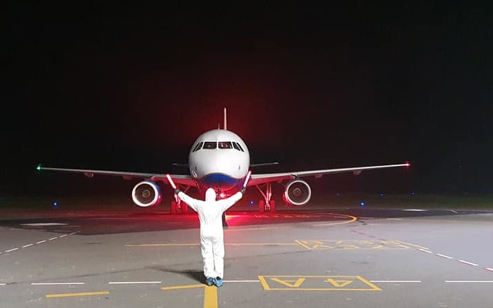A plane arrives at Vanuatu Airport under strict Covid-19 prevention protocols. April 2020