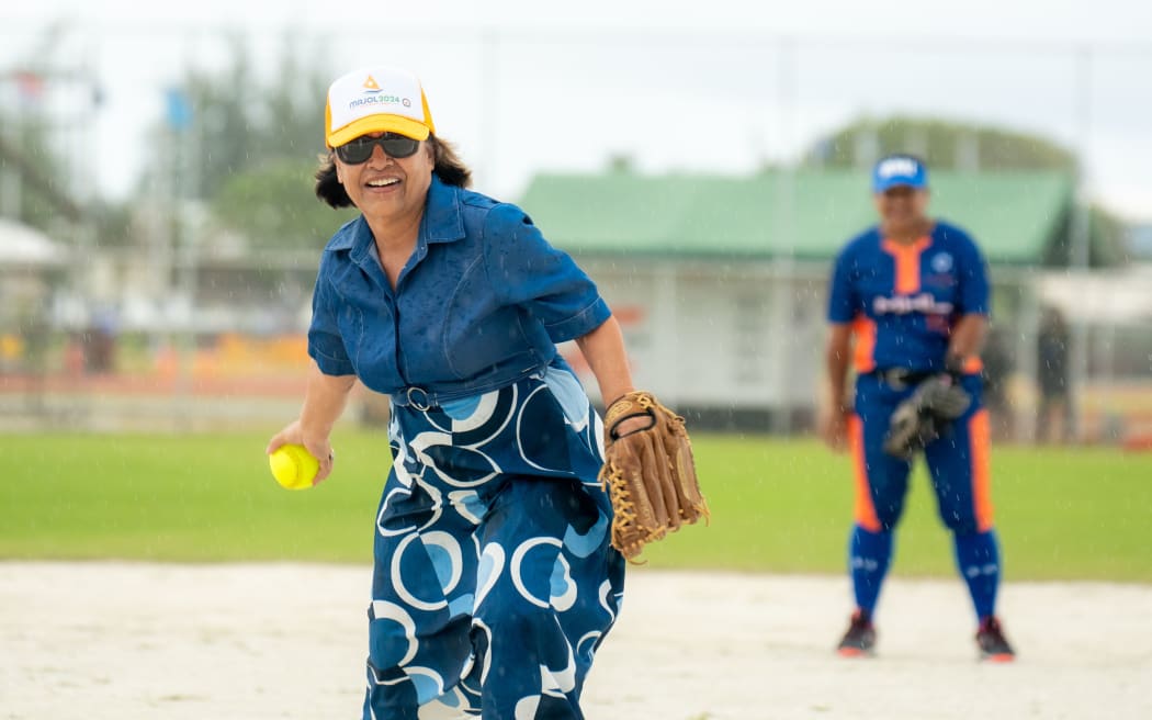 Marshall Islands President Hilda Heine throws out the first pitch Monday to kick off the women's fast-pitch softball tournament. Photo: Chewy Lin.