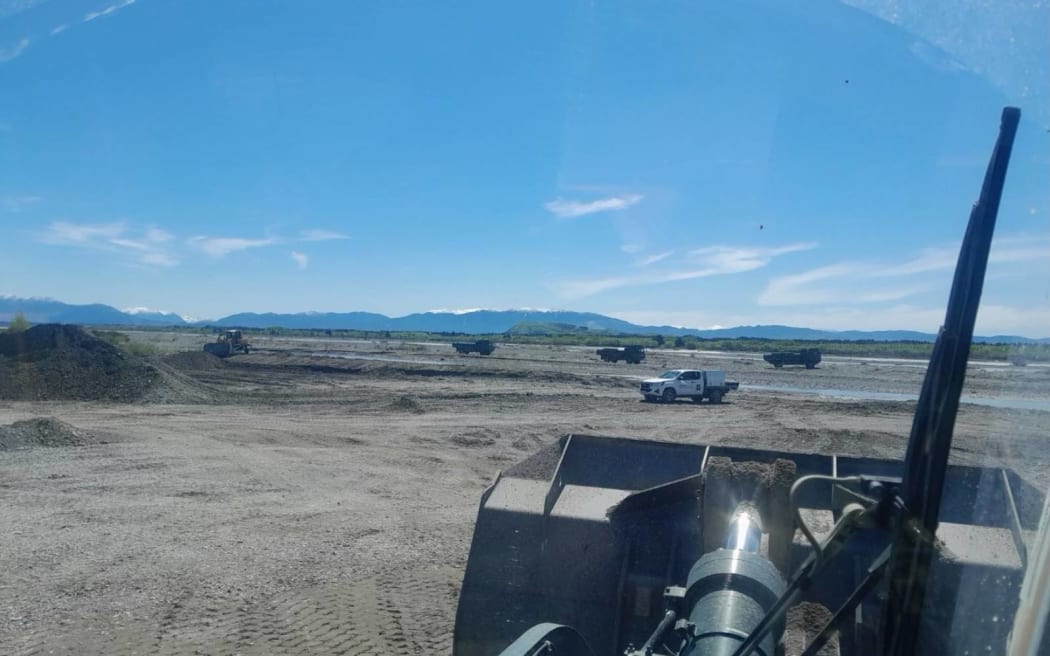 NZ Defence Force vehicles in the Waimakariri River, driving across a nesting bird habitat.