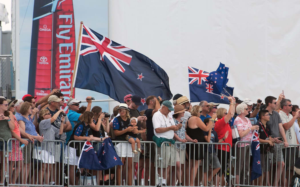 Team New Zealand supporters cheer for the team as they leave the dock on day one of the challenger playoff finals against Artemis.