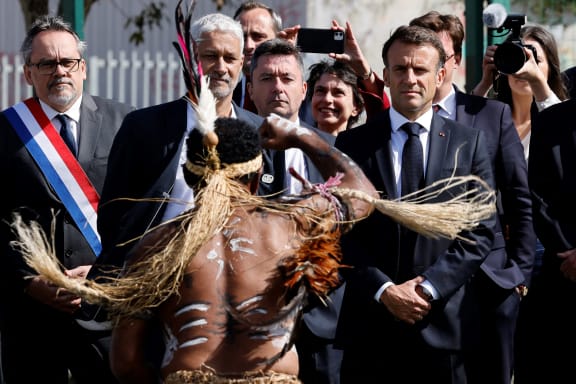 French President Emmanuel Macron (R) watches the Haka performance in Noumea.
