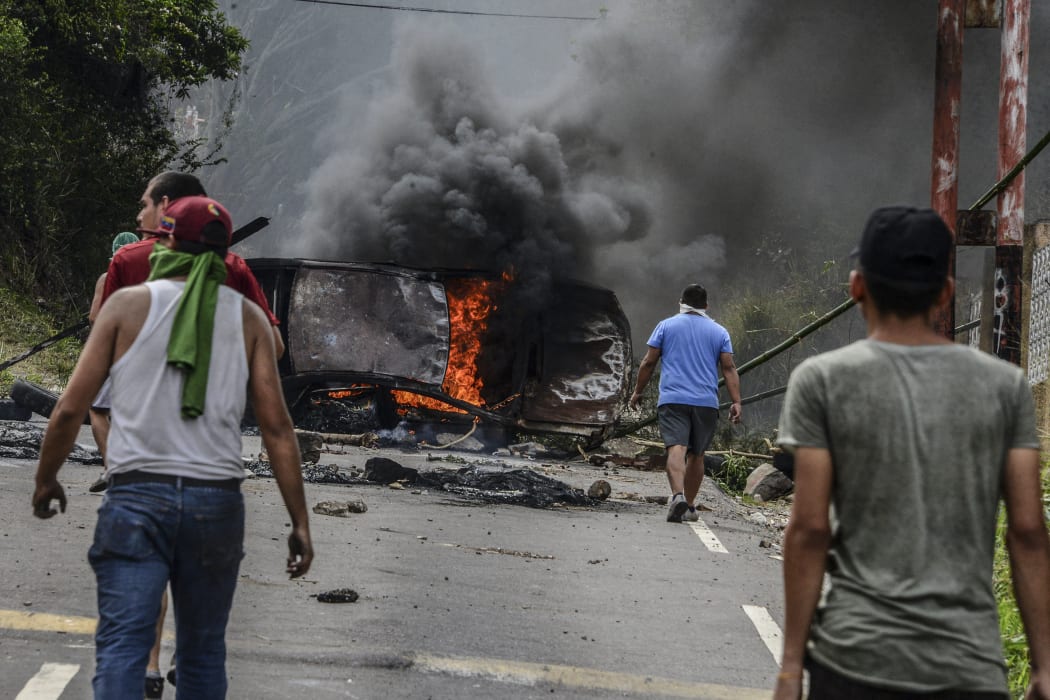 Venezuelan opposition activists set up barricades during a demonstration against President Nicolas Maduro in San Cristobal, on April 24, 2017.