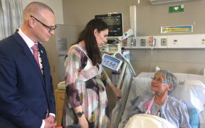 Prime Minister Jacinda Ardern and Health Minister David Clark visit a patient at NortH Shore Hospital.