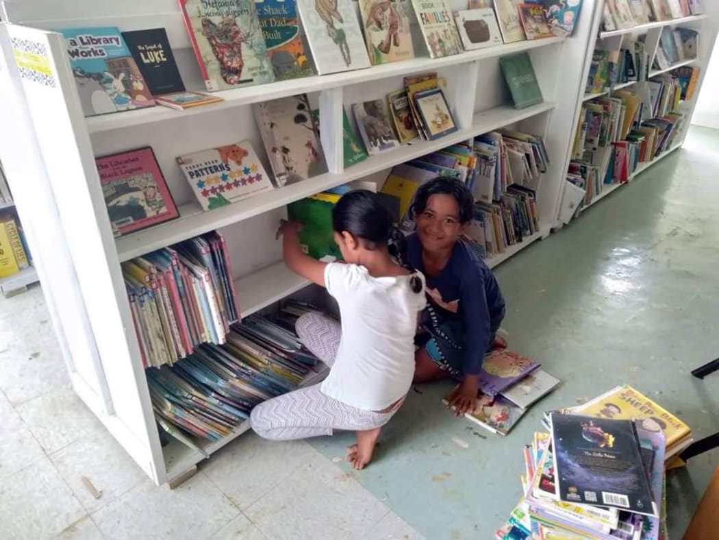 Local children shelving books in Tonga's first public library