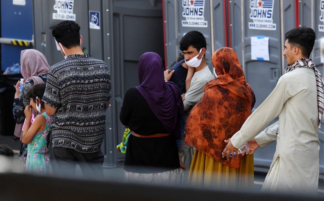 Afghan refugees arrive at a processing center in Chantilly, Virginia, on August 23, 2021, after arriving on a flight at Dulles International Airport.