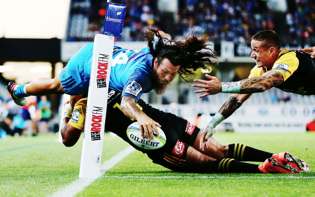 Blues winger Rene Ranger somehow manages to evade the Hurricanes defence to score for the Blues.
