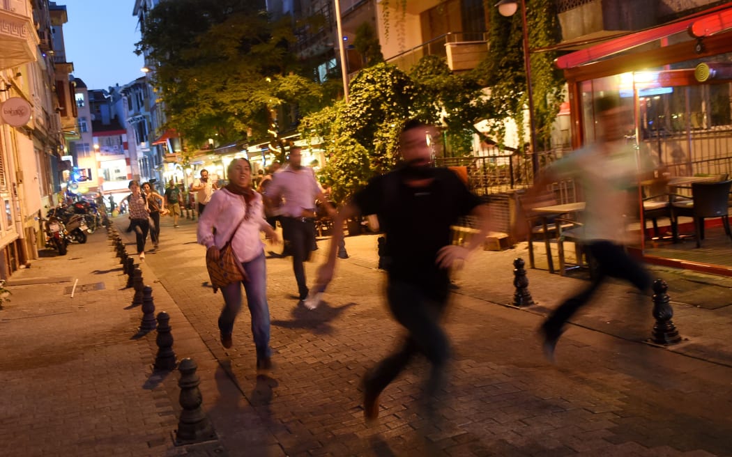 Protesters run away from police officers during a demonstration at Kadikoy district in Istanbul on July 21, 2015, a day after a suicide bomb attack blamed on the Islamic State killed 32 people in Suruc.