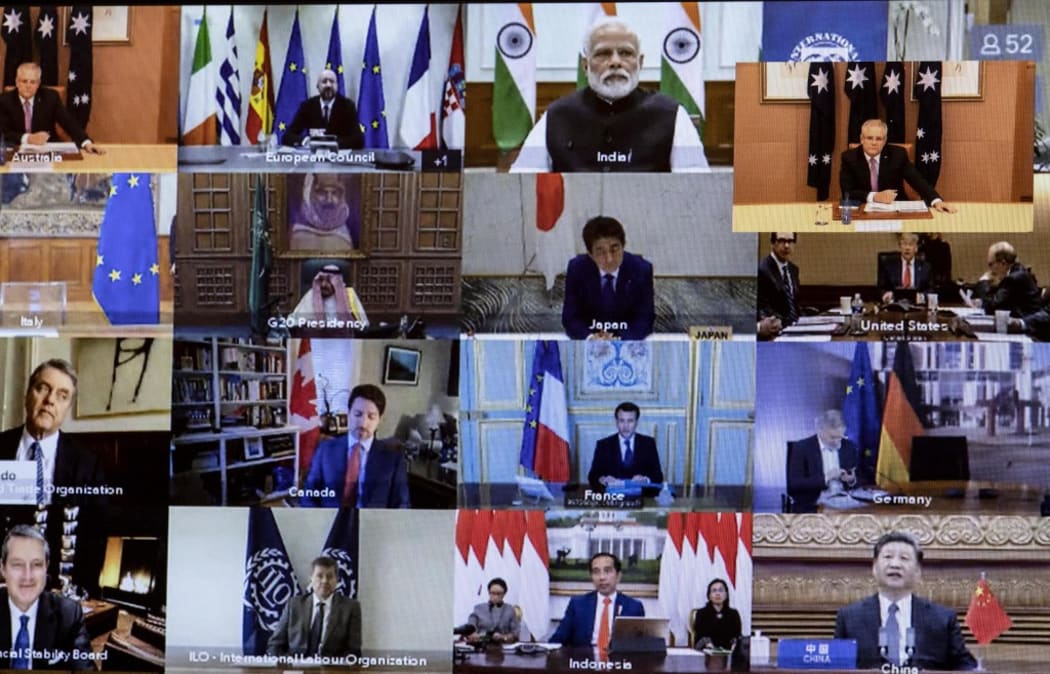 Australian Prime Minister Scott Morrison (Top-R) is seen on a screen attending a videoconference with G20 leaders to discuss the COVID-19 coronavirus, at the Parliament House in Canberra on March 26, 2020.