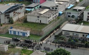 Aerial view showing security forces during an operation at the Regional 8 prison complex in Guayaquil, Ecuador, on January 18, 2024. The Ecuadoran army and police on Thursday launched an operation in a vast penitentiary complex in the port city of Guayaquil, the nerve center of the government's war on drug gangs. (Photo by Marcos PIN / AFP)