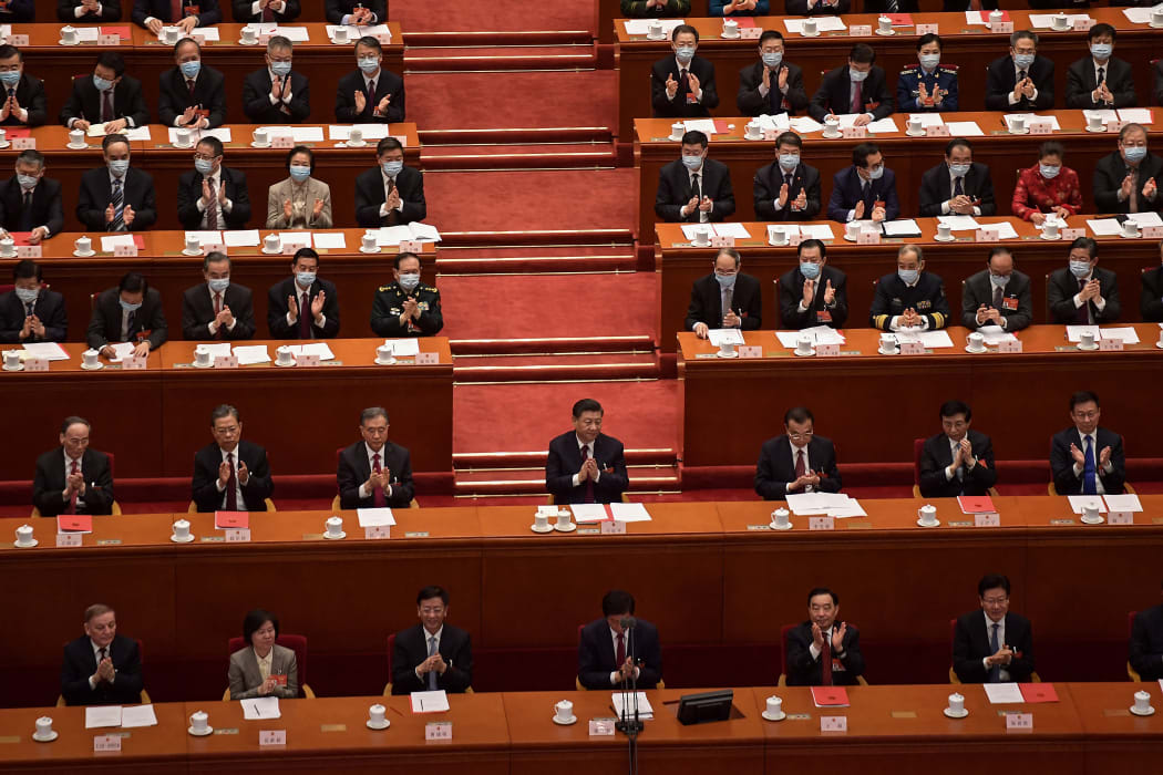 China's President Xi Jinping (centre) applauds with other leaders after the result of the vote on changes to Hong Kong's election system was announced in a session of the National Peoples Congress on Thursday.