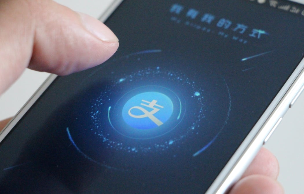A Chinese mobile phone user with Alibaba's online payment service Alipay app.