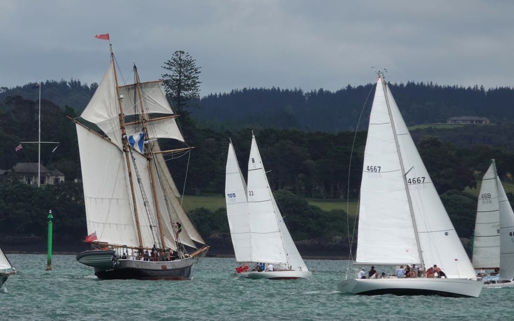 The schooner R Tucker Thompson passes the Waitangi Treaty Grounds under full sail.