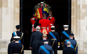 The Bearer Party take the coffin of Queen Elizabeth II, from the State Hearse, into St George's Chapel inside Windsor Castle on September 20, 2022.