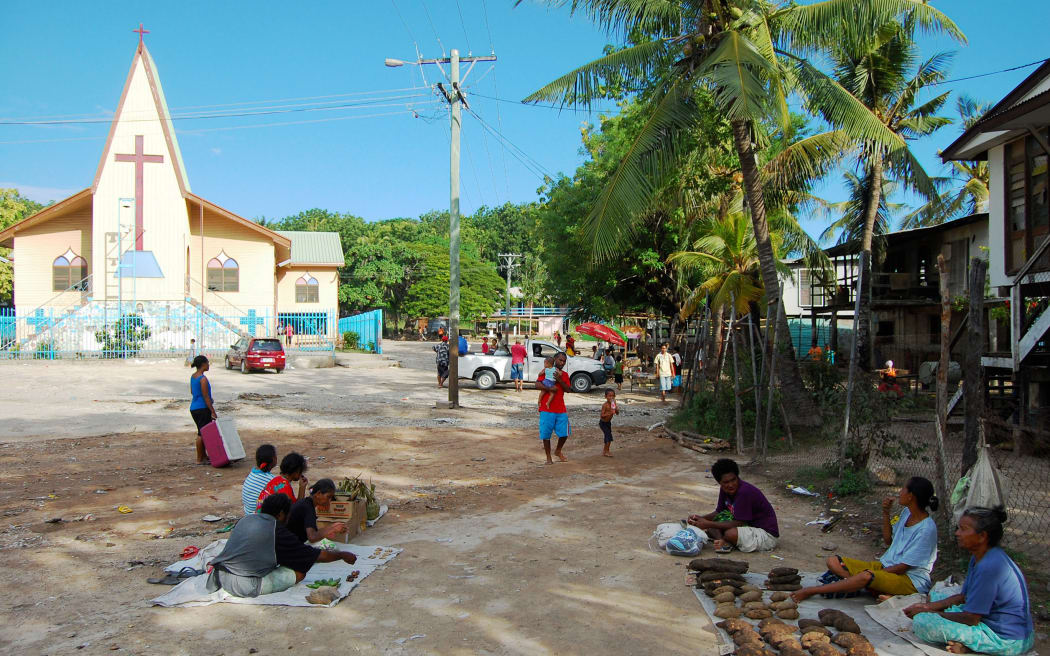 Village market near christian church building, Papua New Guinea