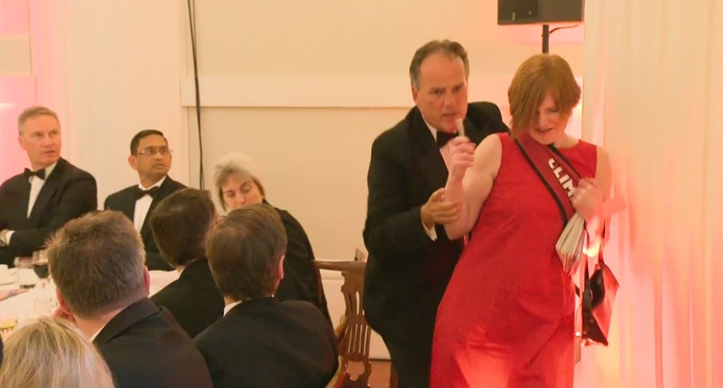 A still image taken from UK Pool video footage on June 21, 2019 shows Conservative MP Mark Field tackling a Greenpeace climate protester at a dinner at Mansion House in the City of London on June 21, 2019.