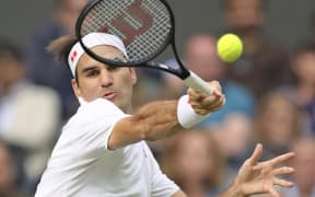 Roger Federer of Switzerland hits a ball during the Men's singles Quarter-finals of the Championships, Wimbledon against Hubert Hurkacz of Poland at the All England Lawn Tennis and Croquet Club in London, United Kingdom on July 7, 2021.