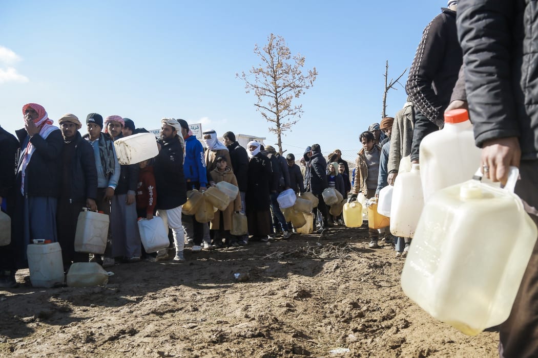 Refugees who fled the Iraqi city of Mosul due to the fighting between government forces and Islamic State, queue for heating fuel at the UN-run al-Hol refugee camp in Syria in 2017.