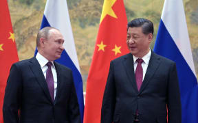 Russian President Vladimir Putin (L) and Chinese President Xi Jinping pose for a photograph during their meeting in Beijing, on 4 February 2022.
