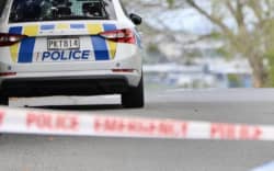 A police car seen behind a cordon as officers attend an incident.