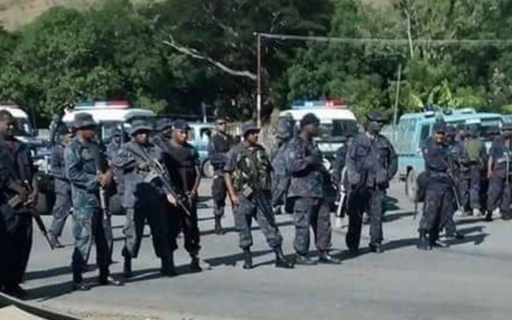 Police stand at the students protests.