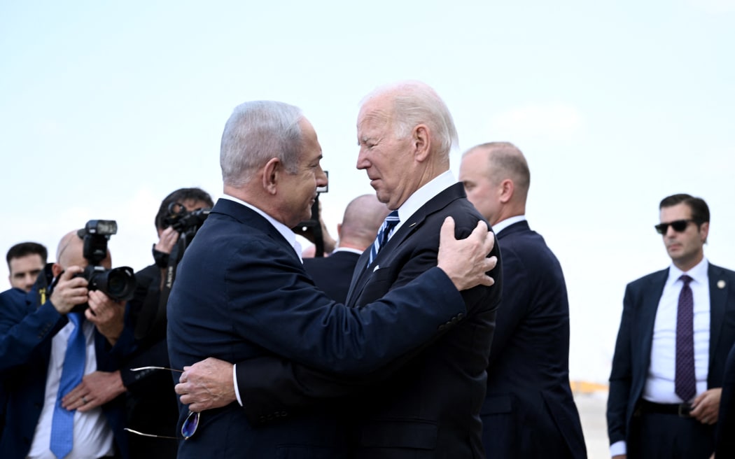 Israel Prime Minister Benjamin Netanyahu, left, greets US President Joe Biden upon his arrival at Tel Aviv's Ben Gurion airport on October 18, 2023, amid the ongoing battles between Israel and the Palestinian group Hamas.  (Photo by Brendan SMIALOWSKI / AFP)
