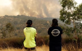 People watch as a fire burns in Perth