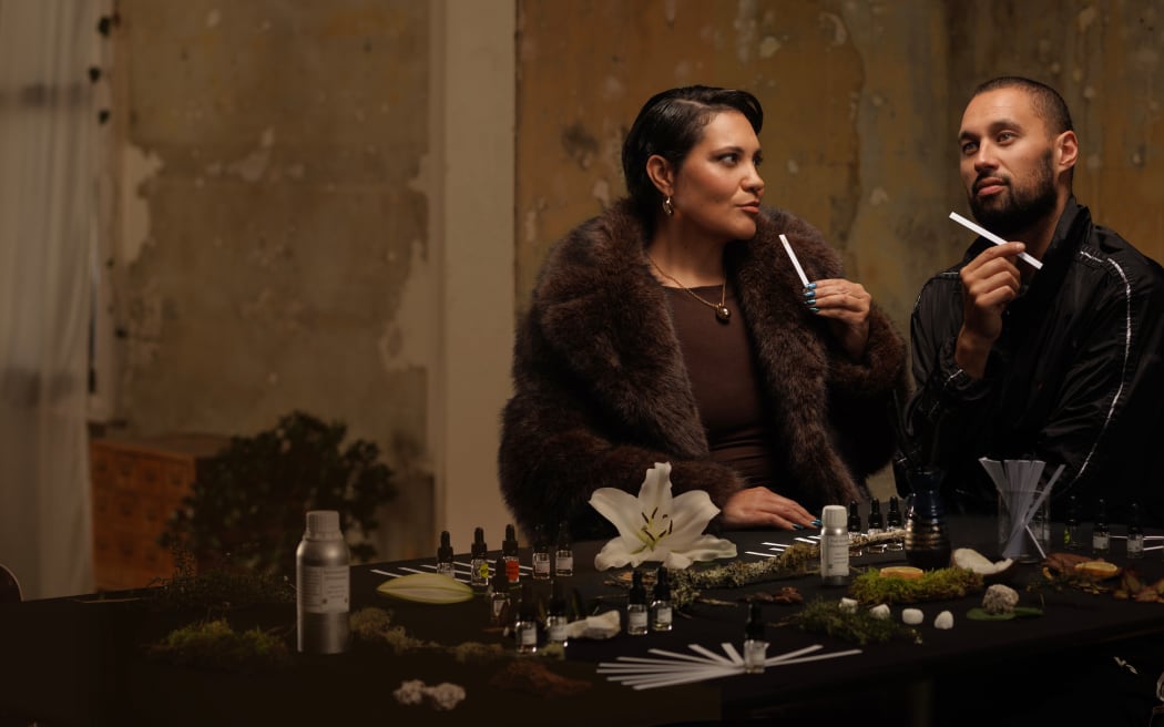 The hosts of Journey of Scent sit at a table, smelling samples of a new perfume.