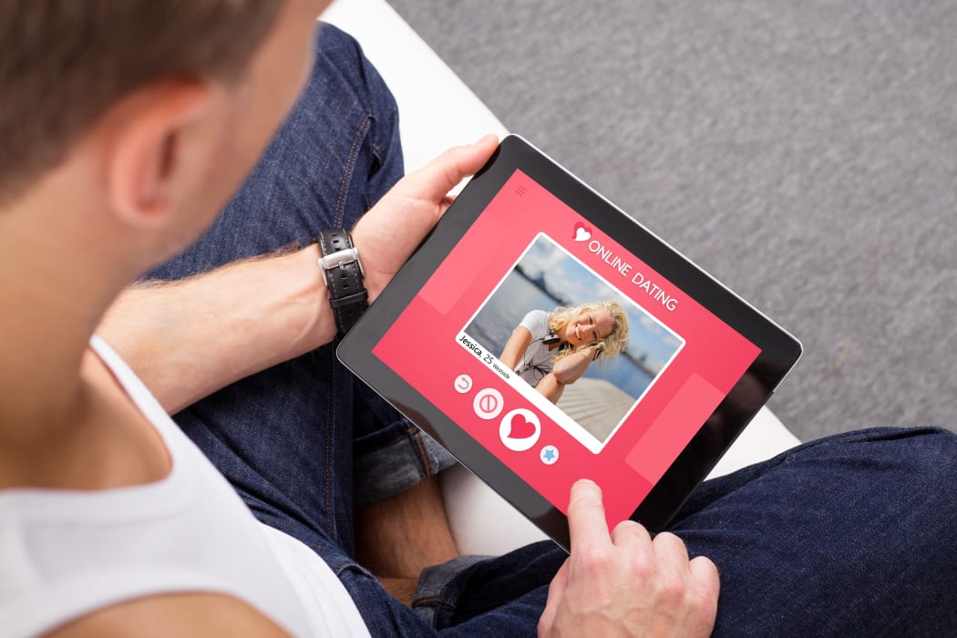 67741981 - man using online dating app on tablet