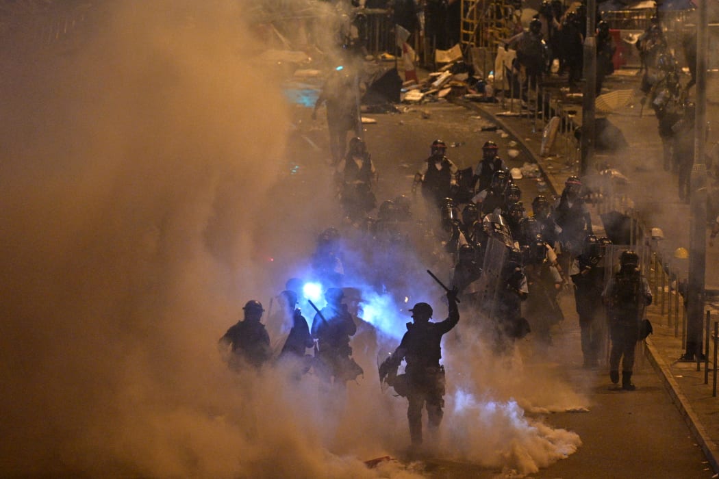 Police fire tear gas at protesters near the government headquarters in Hong Kong on 2 July 2019.
