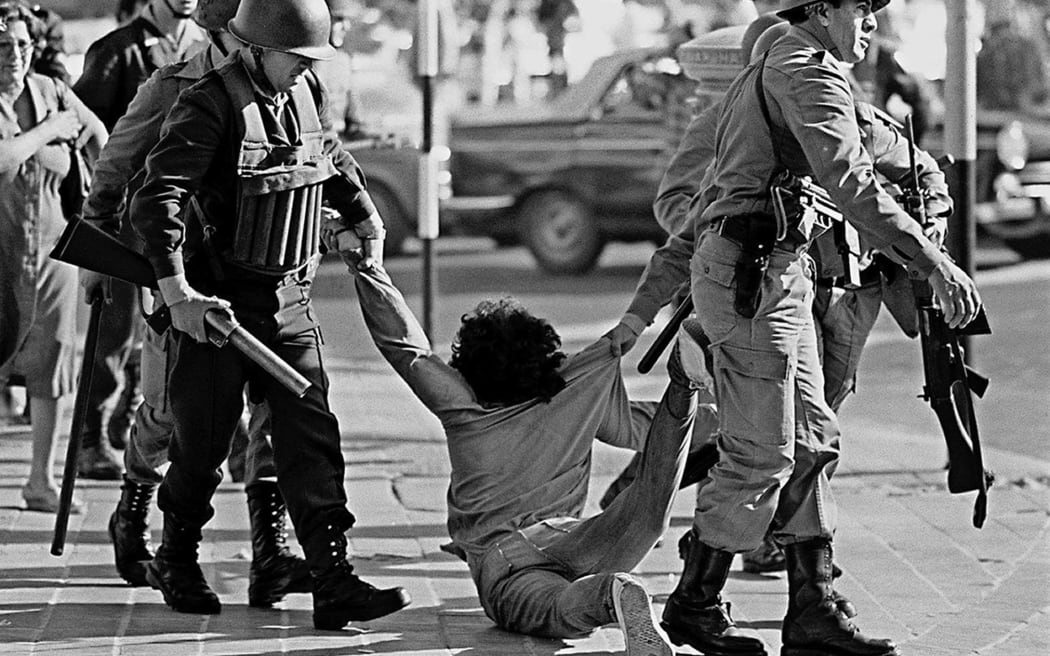 Picture taken 30 March 1982 of a worker who is being arrested during a protest against Argentine dictatorship (1976-1983) in Buenos Aires.